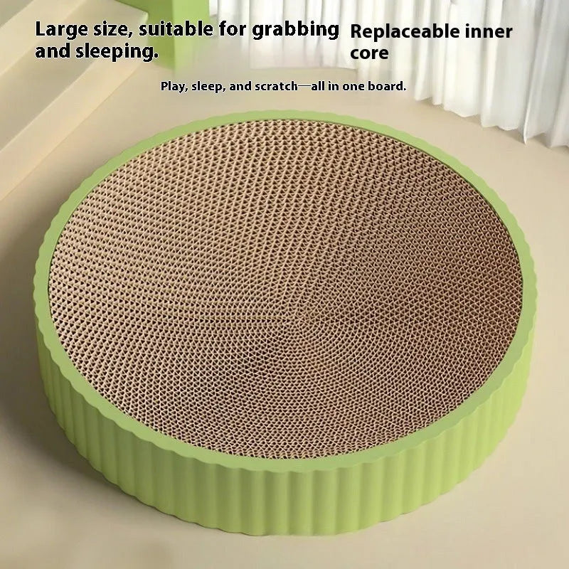 Green and white round cat scratching board with corrugated paper centre and raised nest edge.
