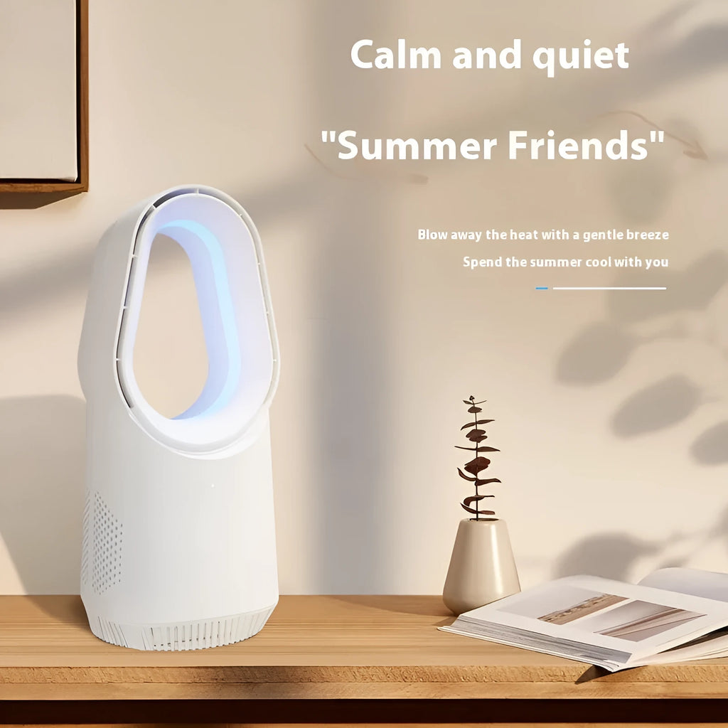 A white bladeless tower fan with a remote control on a wooden floor next to a desk.