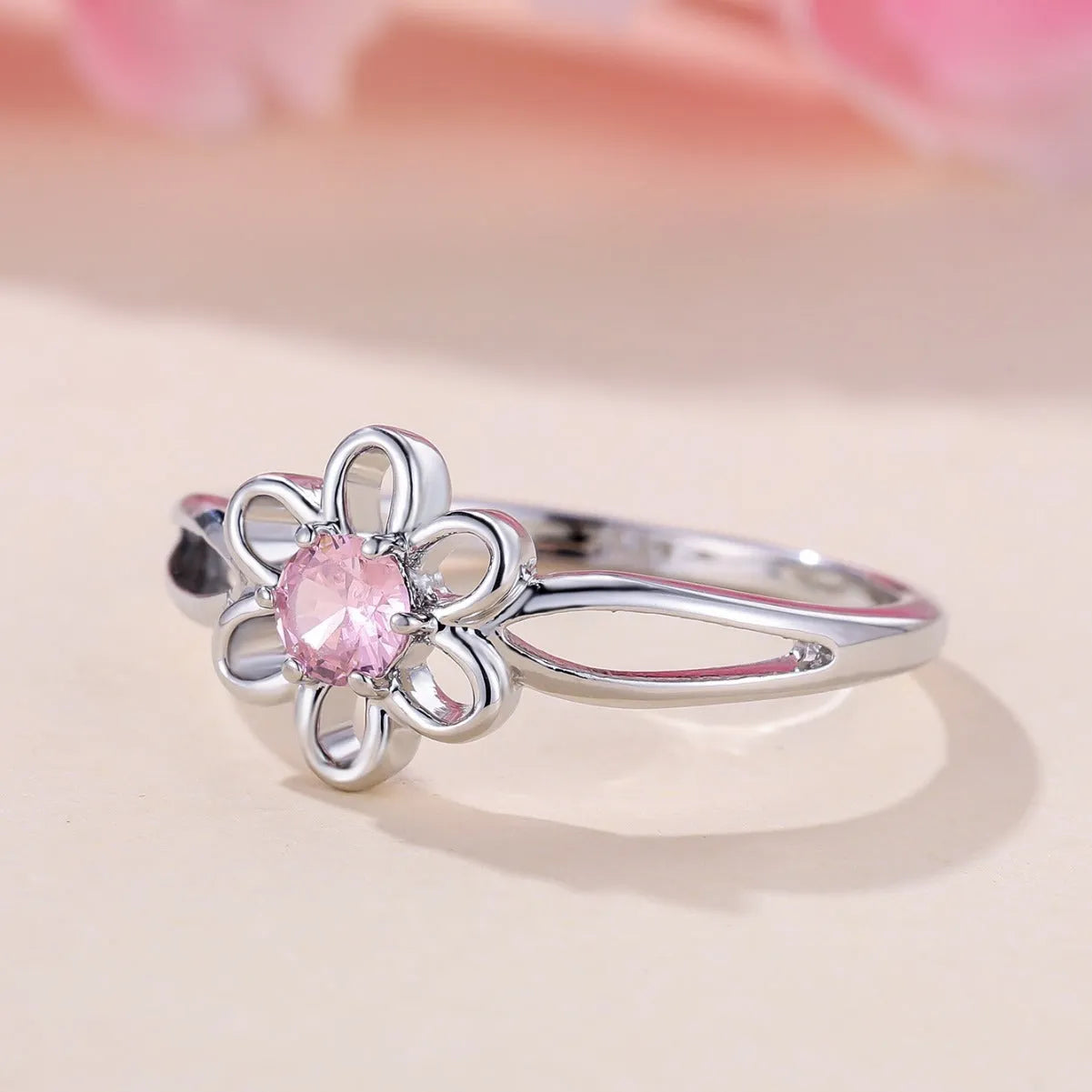Women's electroplated copper ring with floral hollowed design in platinum pink diamond colour
