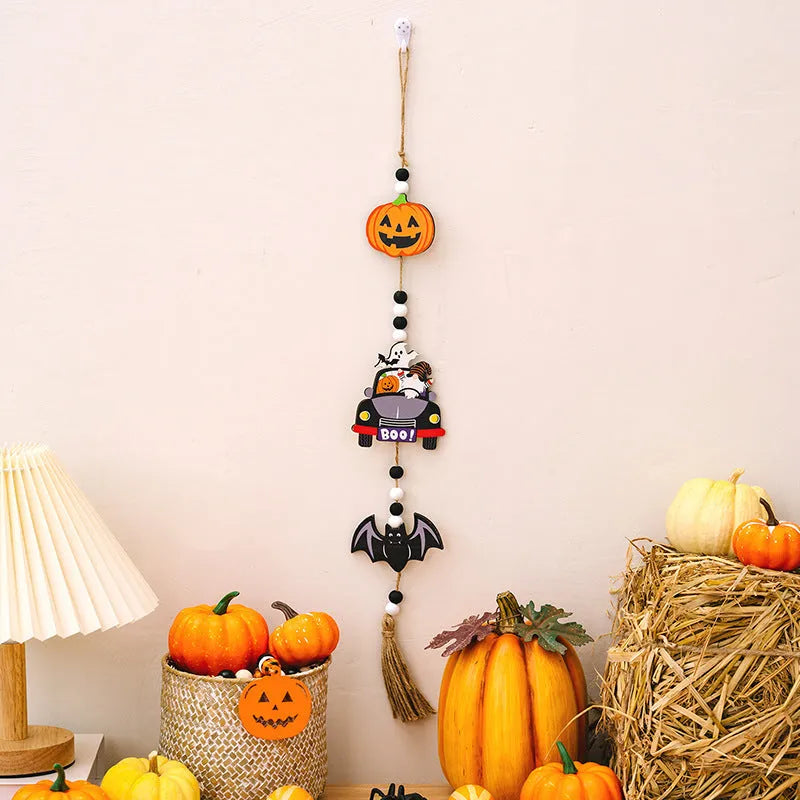 Resin Halloween pendant string with BOO ghost design hanging on a wall