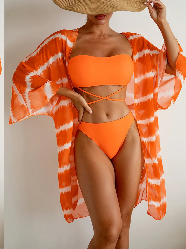 Women's orange three piece swimsuit with nylon colour blocking fabric, bra, panties and cardigan.