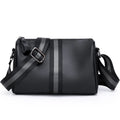 Black genuine leather one-shoulder crossbody bag showing its large size and crossbody strap.