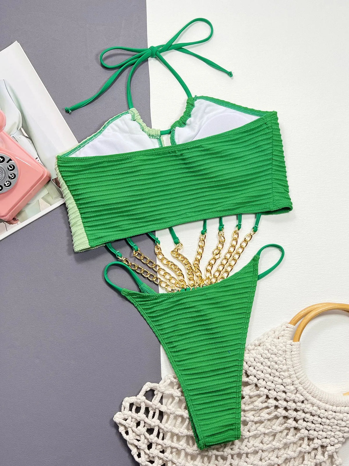 Green solid colour women's one-piece swimsuit on a mannequin