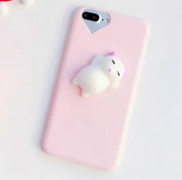 Soft pink silicone TPU phone case with a raised 3D cartoon cat design on the back, fitted to an iPhone.