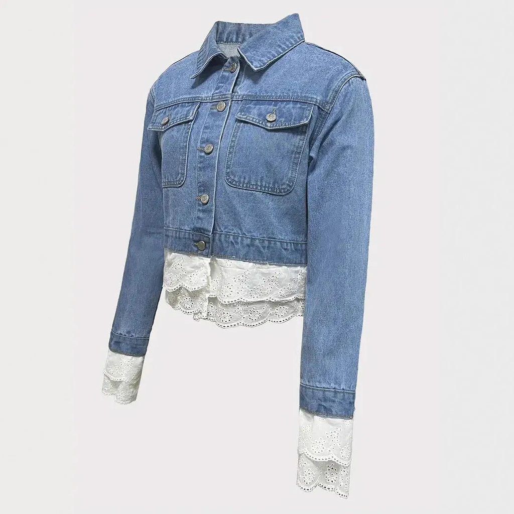Blue women's denim jacket with white lace stitching on the front, long sleeves.
