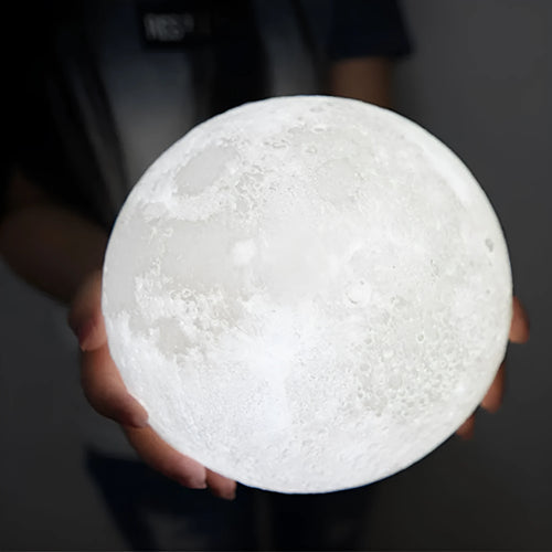 3D printed white moon lamp on a wooden stand with touch-control ring at base
