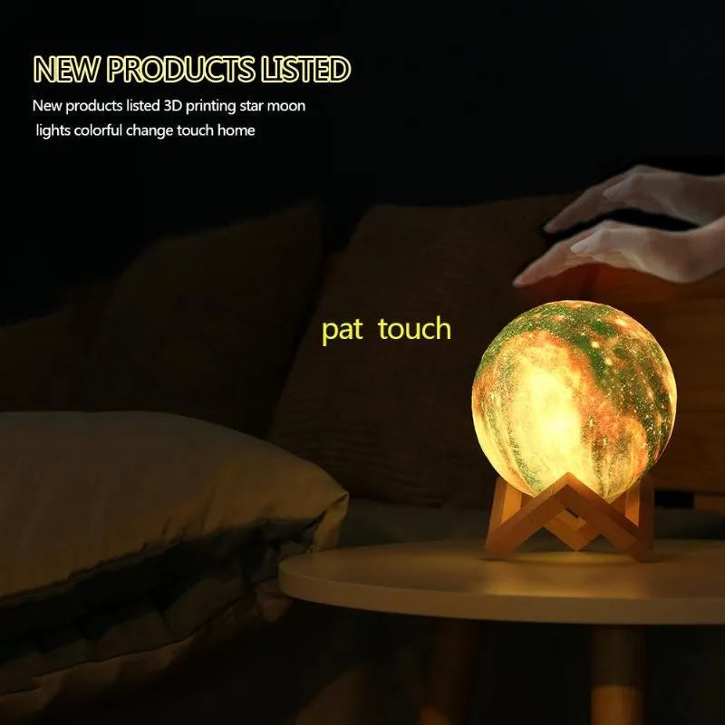 3D printed spherical moon night light glowing with multi-colour LED light on a dark surface.