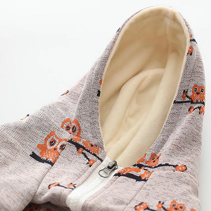 Blue dog sweater with front zipper closure and animal pattern design on mannequin
