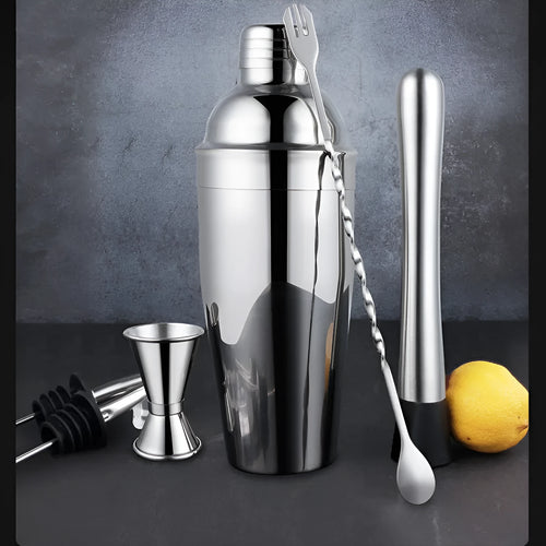 Silver 23-piece stainless steel and acrylic home cocktail set with bartender tools laid out.