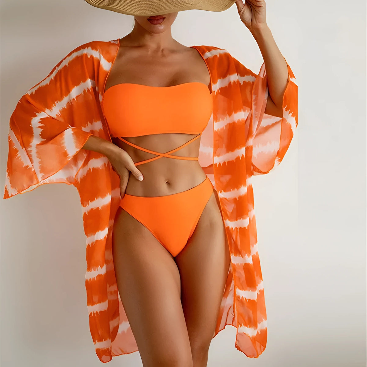 Women's orange three piece swimsuit with nylon colour blocking fabric, bra, panties and cardigan.
