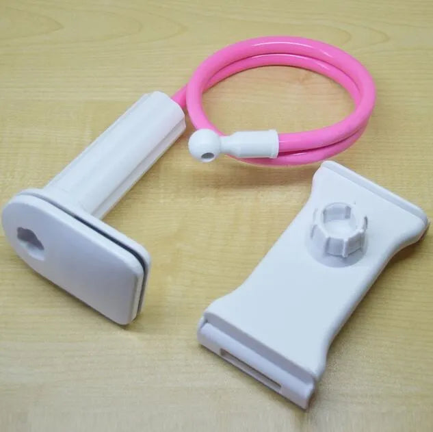 Black aluminium alloy and plastic bedside phone handset with long arm extended on a wooden table.