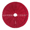 Round wool knitted Christmas tree skirt, 122cm diameter, in red or milky white, shown around a tree base