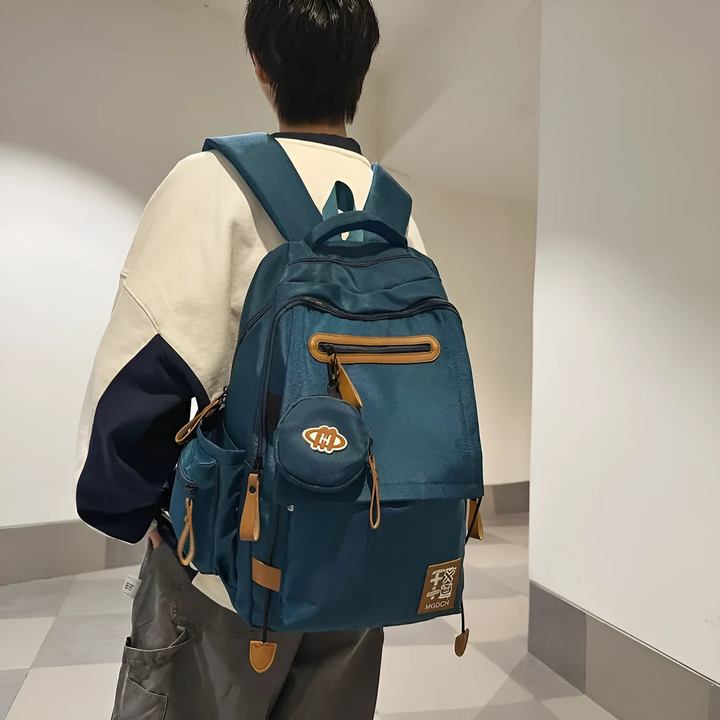 Large black nylon backpack for middle school students with curved shoulder straps and sewing line details