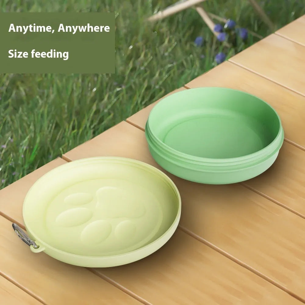 Portable collapsible silicone dog bowl with a clip-on snack compartment lid in green and pink colours