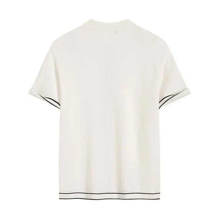 White women's short sleeve cardigan with dark contrast lapels laid flat.