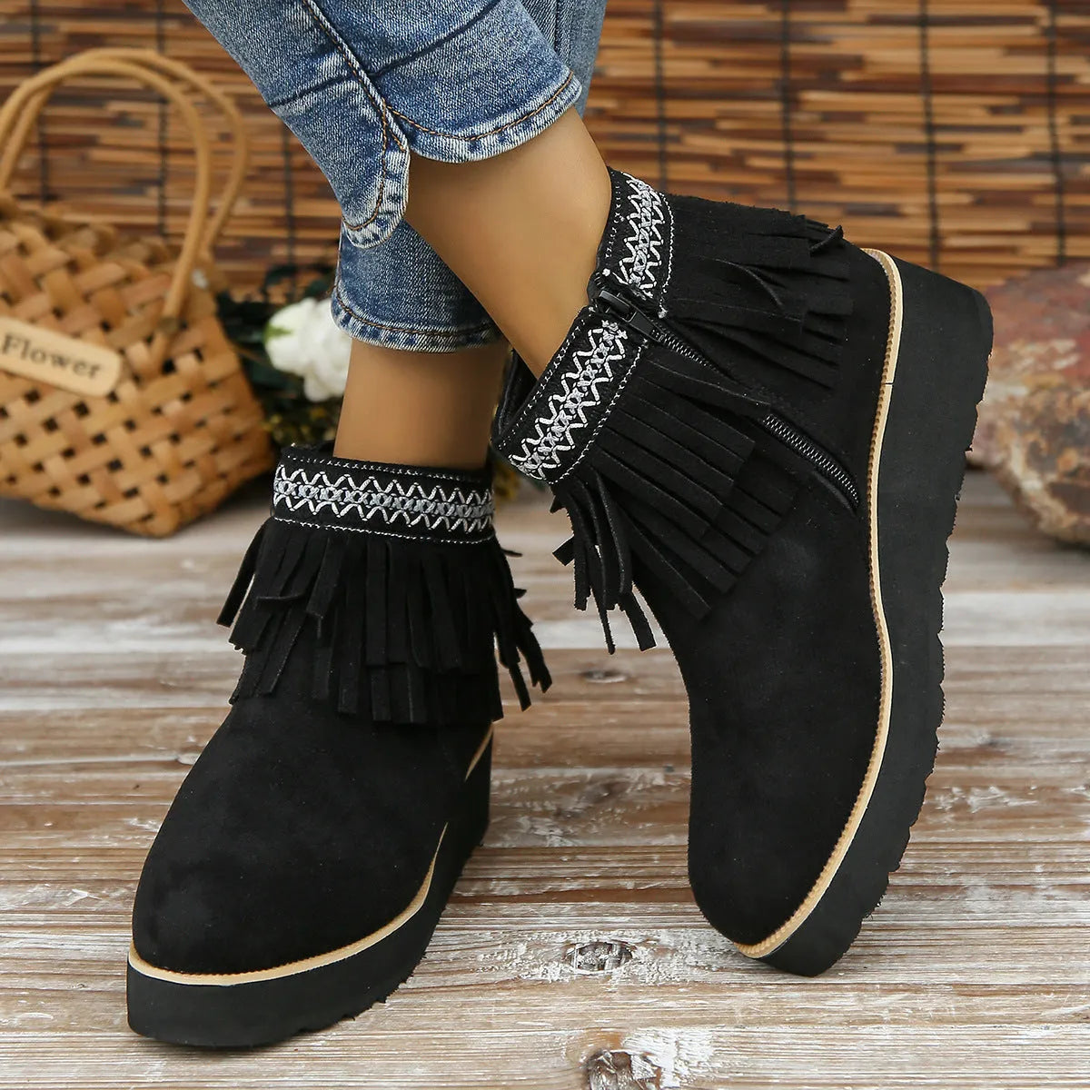 Women's suede ankle boot with wedge heel, side zipper, tassel detail, and thick rubber sole in three colour options.