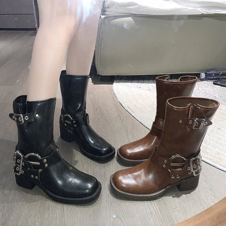 Women's black platform boots with buckle detailing showing middle calf length