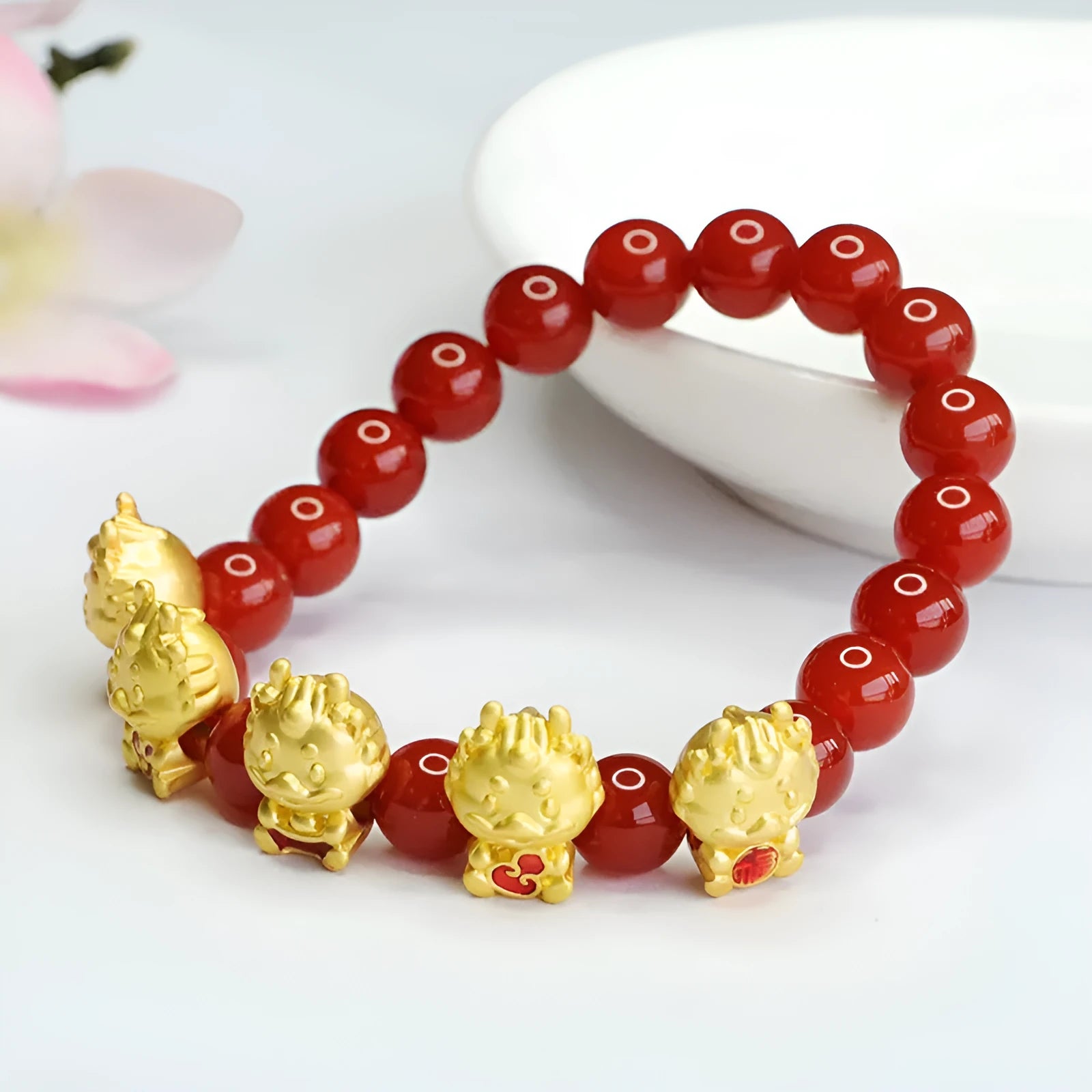 Red agate Five Blessing Dragon bracelet with 8mm beads on a wrist.