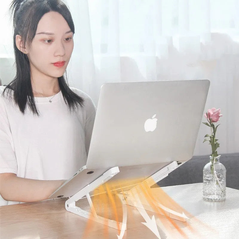 Black ABS folding laptop stand on desk with laptop placed on top
