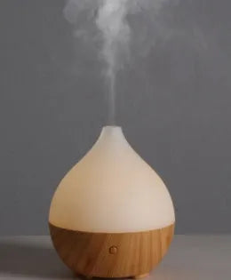 Asakusa wood grain vase-shaped aroma diffuser with USB cable on a wooden surface.