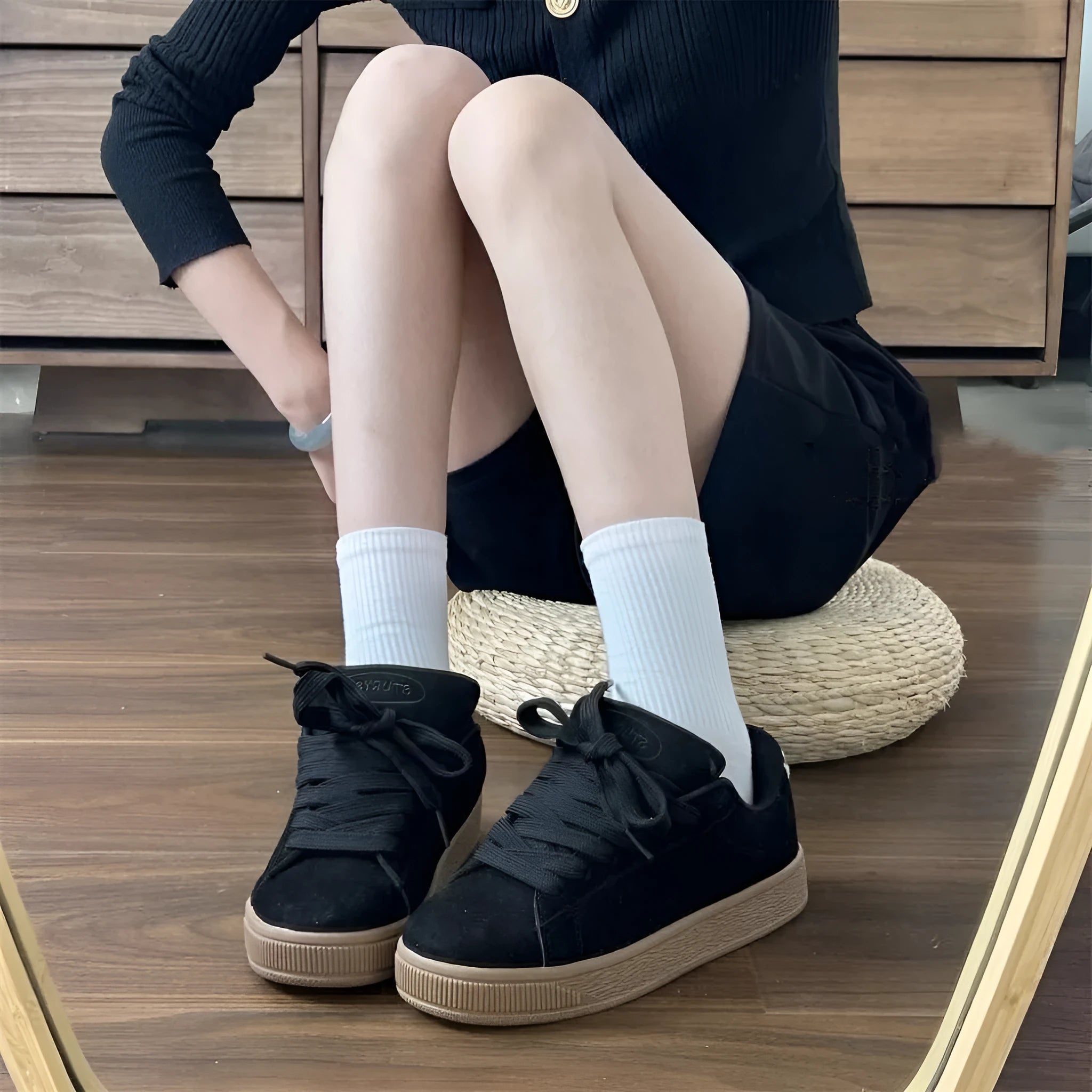 Black retro low-top sneakers with round toe, front lace-up, and waterproof platform sole