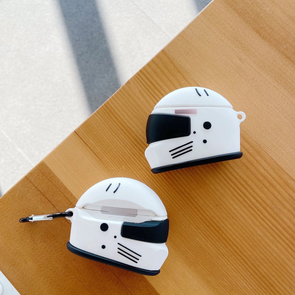 Black silicone AirPods case with motorcycle helmet shape, cartoon geometric design, and carabiner clip