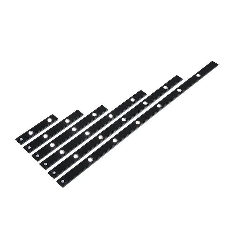 Black geometric cat's eye infrared sensor lamp with three colour light on a cabinet shelf