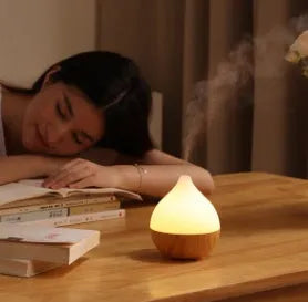 Asakusa wood grain vase-shaped aroma diffuser with USB cable on a wooden surface.