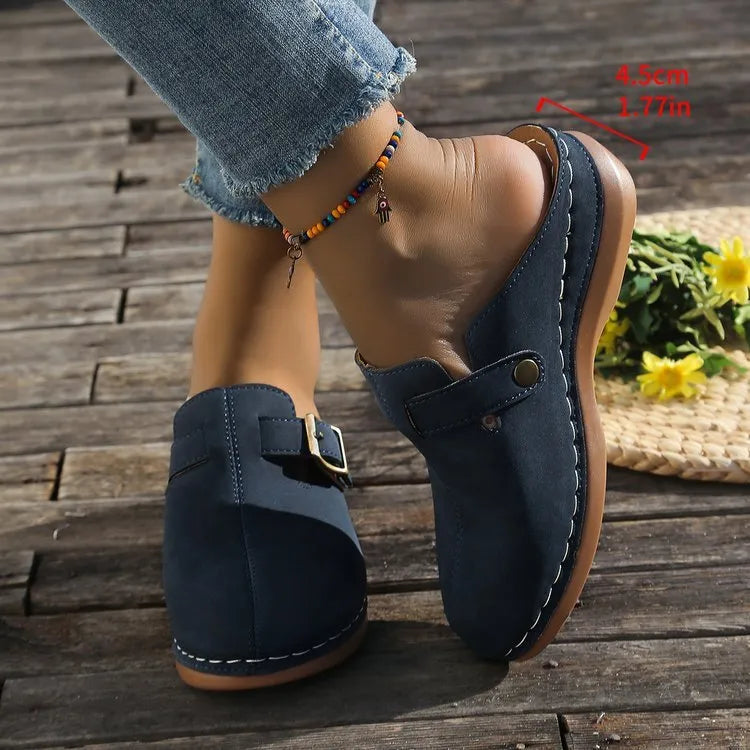 Women's casual wedge slipper in light brown with cloth upper and rubber sole.