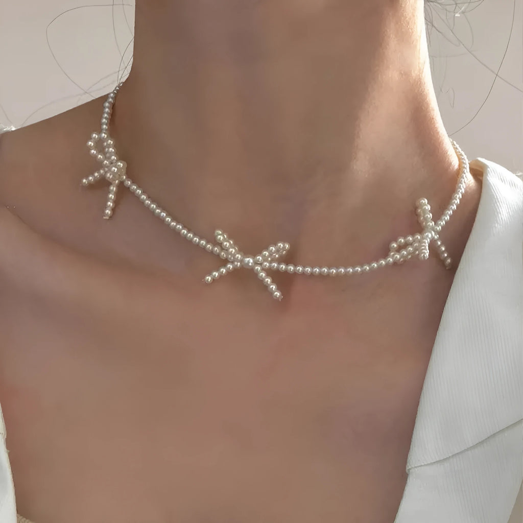 White imitation pearl necklace with bow pendant on adjustable 31-40cm chain