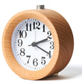 Solid beech wood analogue alarm clock with silent snooze on a wooden bedside table.