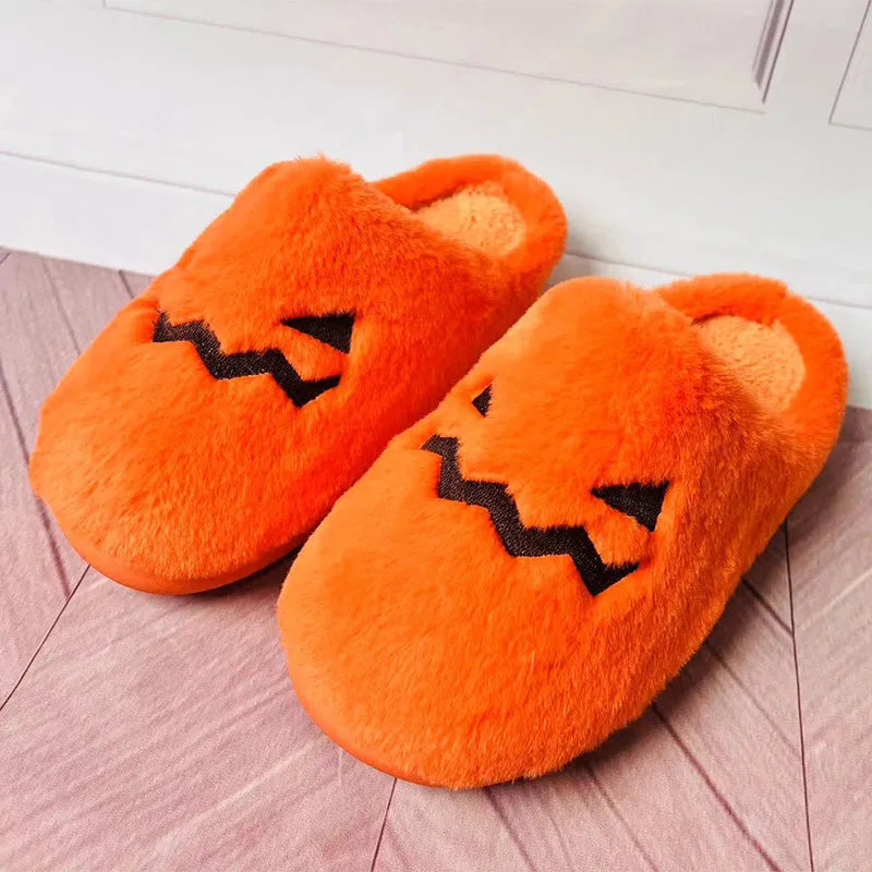 Orange Halloween pumpkin slippers with coral velvet upper and plush lining on a non-slip PVC sole.