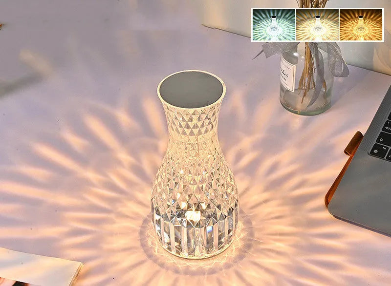 Crystal vase-shaped table lamp with remote control on wooden bedside table