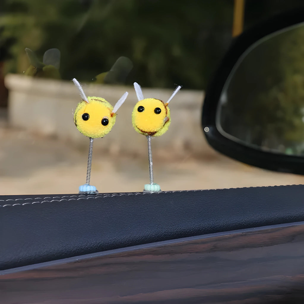 Small yellow and black fur ball bee car decoration ornament measuring 3cm.
