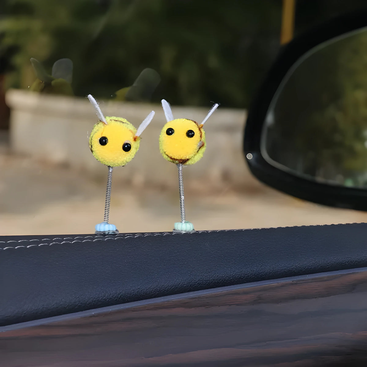 Small yellow and black fur ball bee car decoration ornament measuring 3cm.