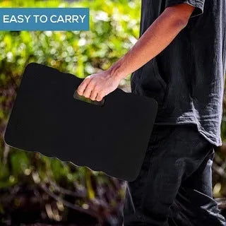 Blue EVA foam garden kneeler pad on grass, showing its rectangular shape and thickness for knee protection.