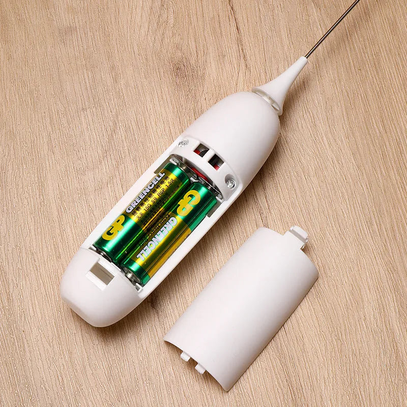 Electric hand-held milk frother in black and white colours for coffee preparation