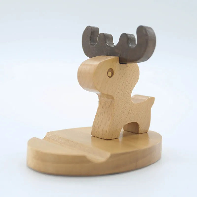 Beech wood mobile phone holder with coin slot in animal design style on wooden desk