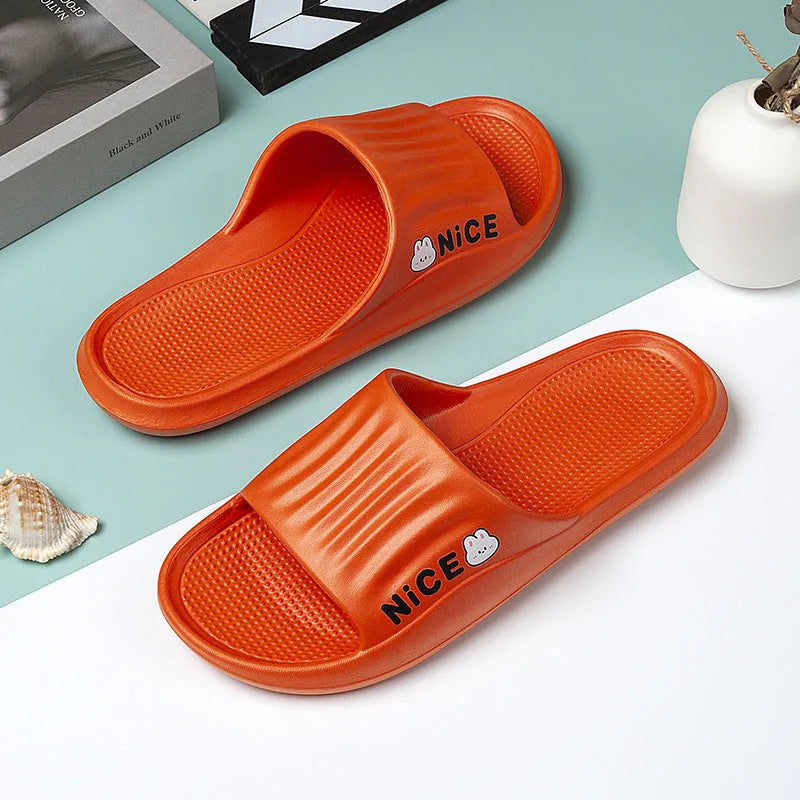Pair of lightweight EVA flip-flop slippers with a minimalist cartoon pattern and non-slip soles.