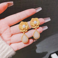 Gold electroplated Hong Kong style flower stud earrings with opal stone and needle rose pearl design