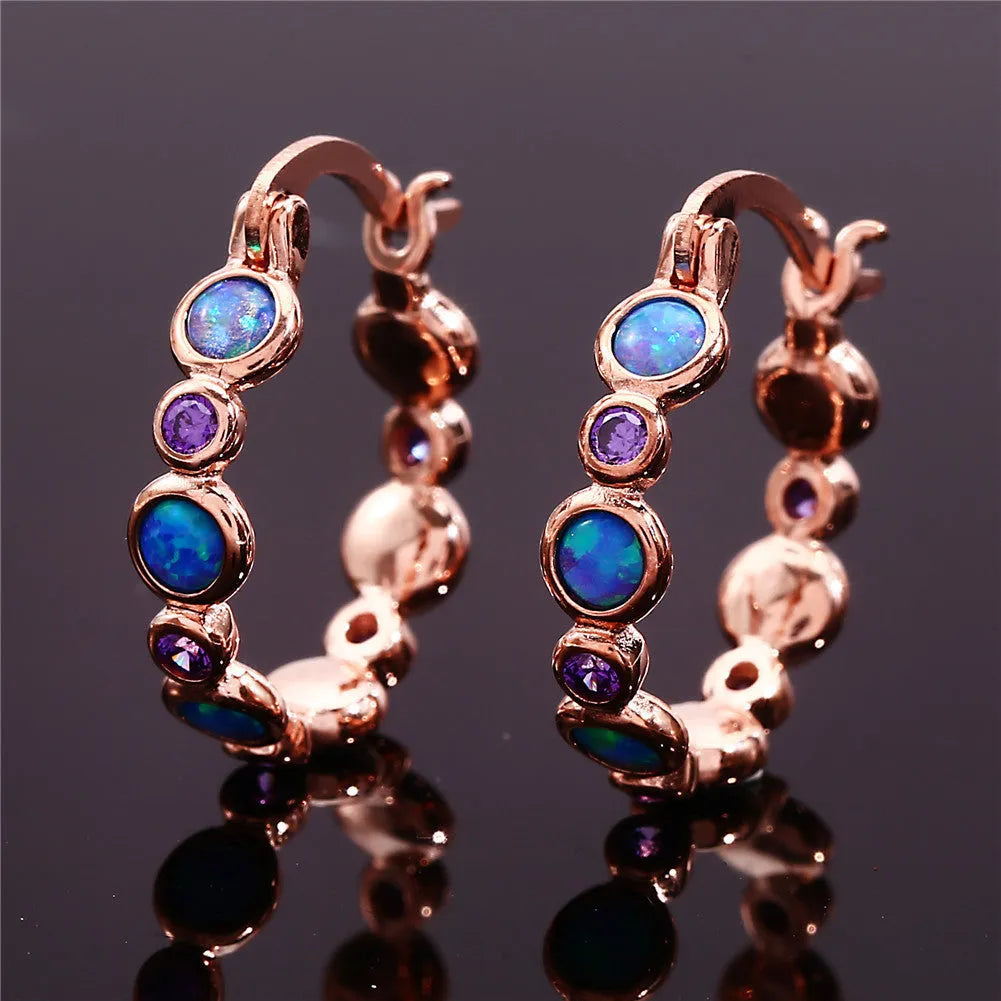 Round copper earrings with synthetic opal and cubic zirconia in platinum white finish