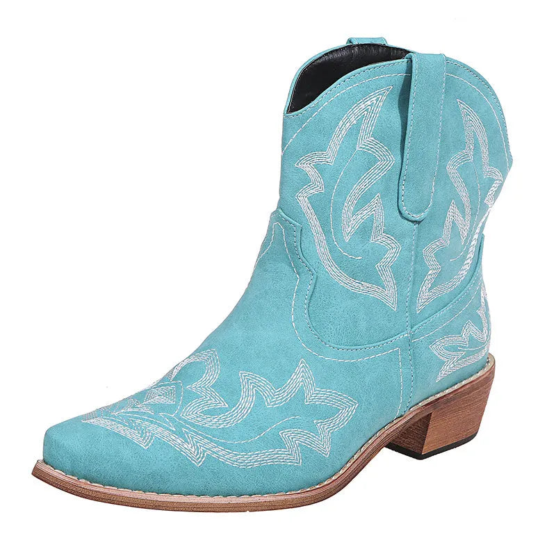 Women's brown cowboy boots with embroidery on the shaft, pointed toe, and a low wedge heel.