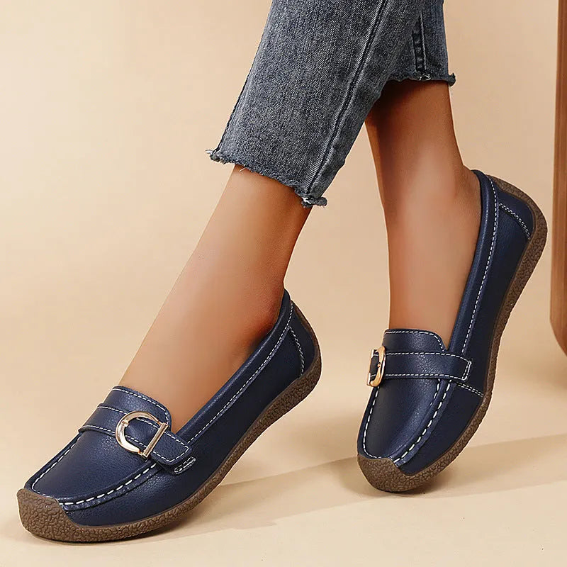 Women's beige casual loafers with round toe and flat heel on a light background.