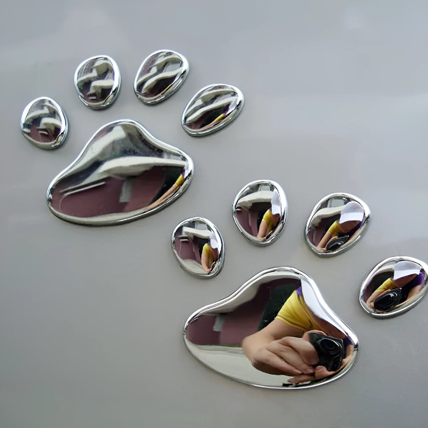 PVC car stickers showing hand-shaped brush design with dog footprints pattern in four colour options