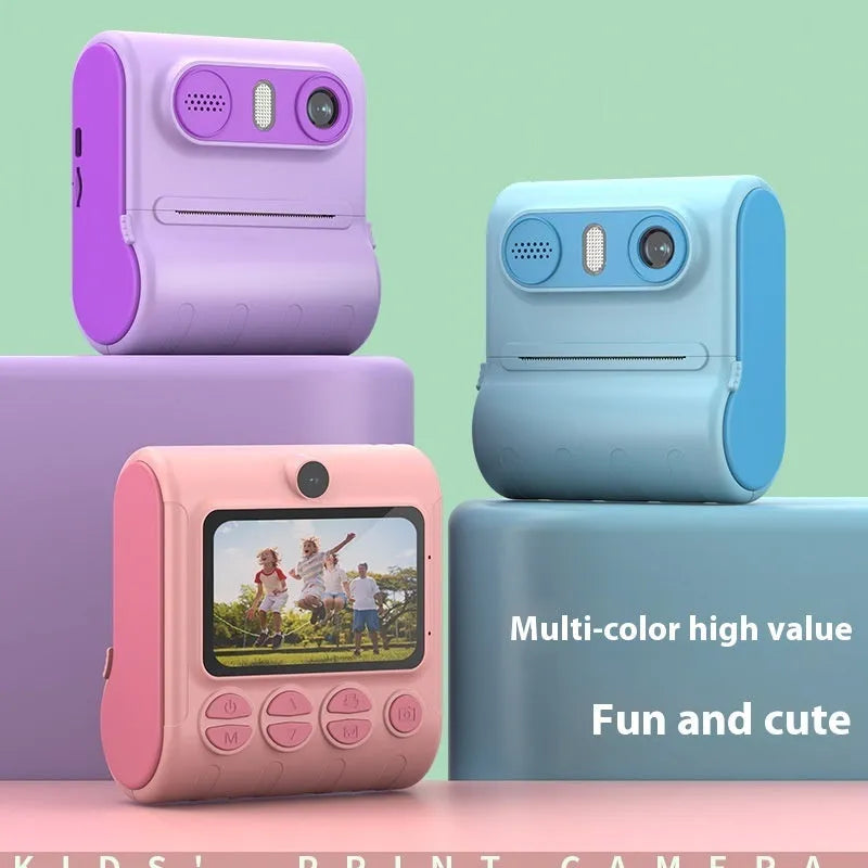 Children's instant printing camera with dual HD cameras in pink colour, showing included lanyard and printing paper