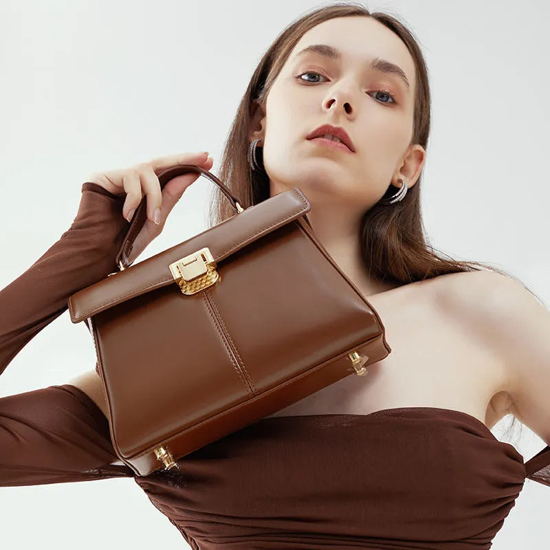 Women's black leather shoulder bag with vachette clasp and horizontal square shape