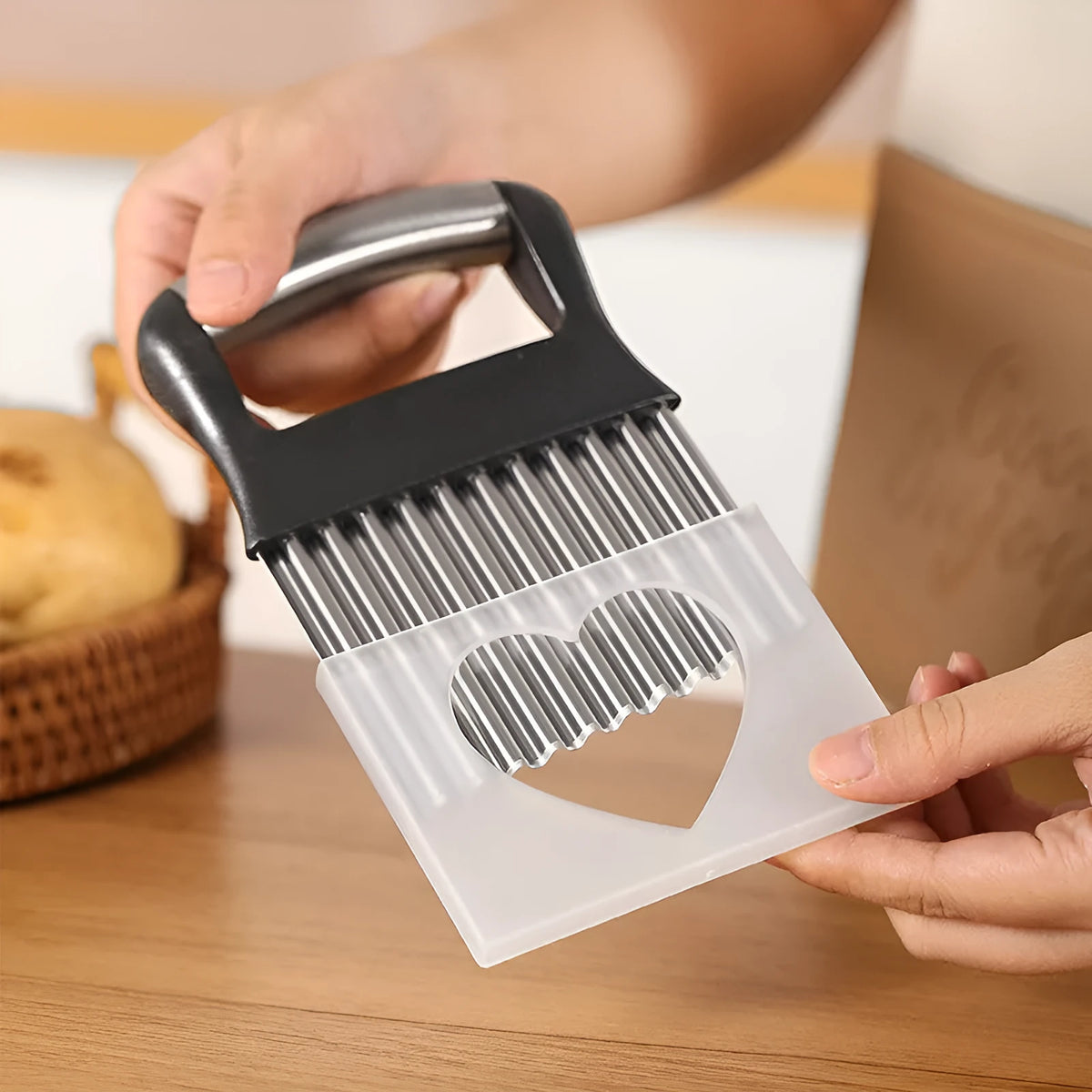 Stainless steel potato wave knife with crinkle-cut blade on a kitchen worktop