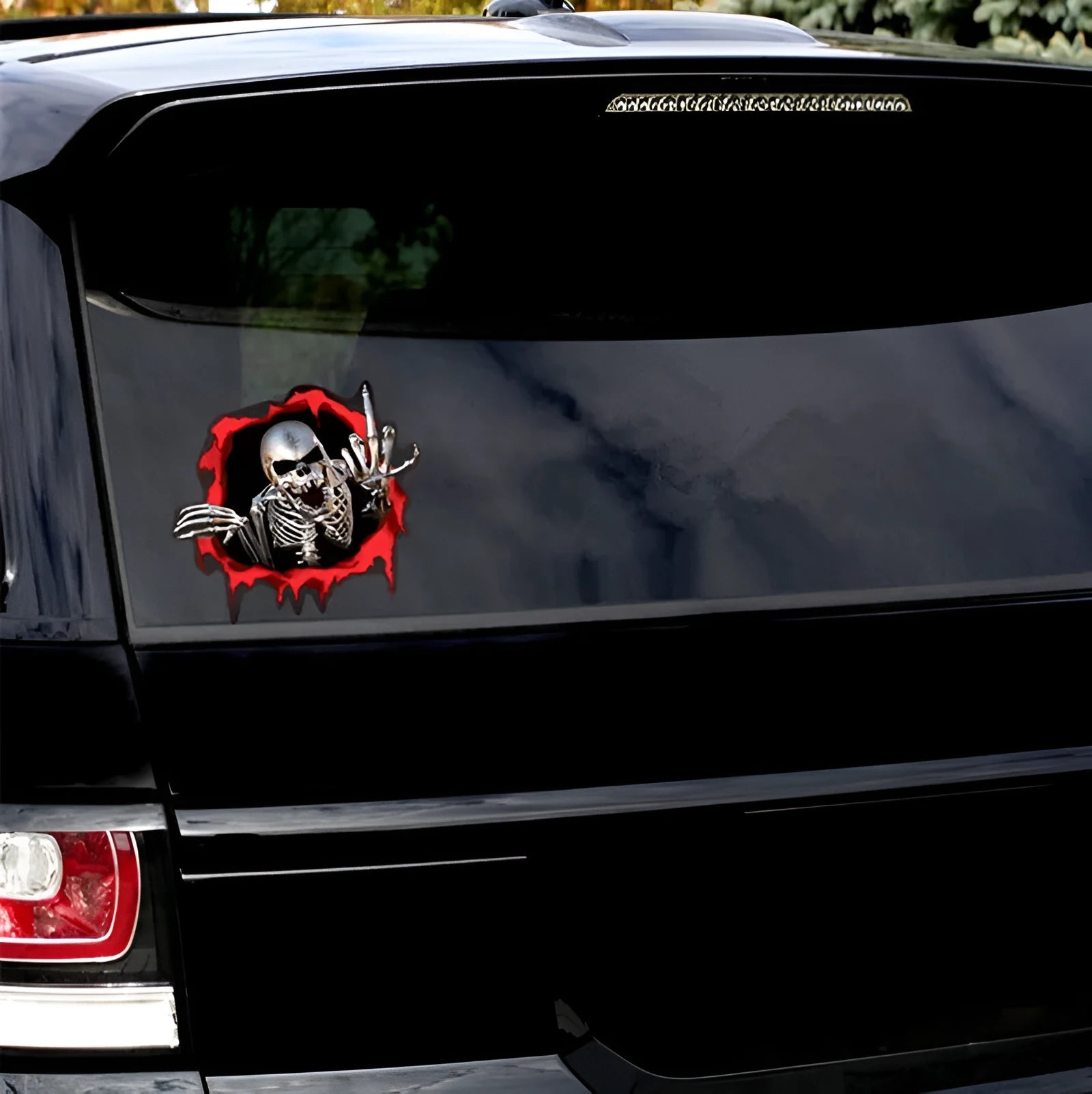 Colourful reflective metal skull bumper sticker on a car bumper.