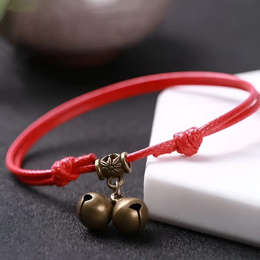 A nylon rope dog collar with a brass bell, shown in black, red, and coffee colour options.