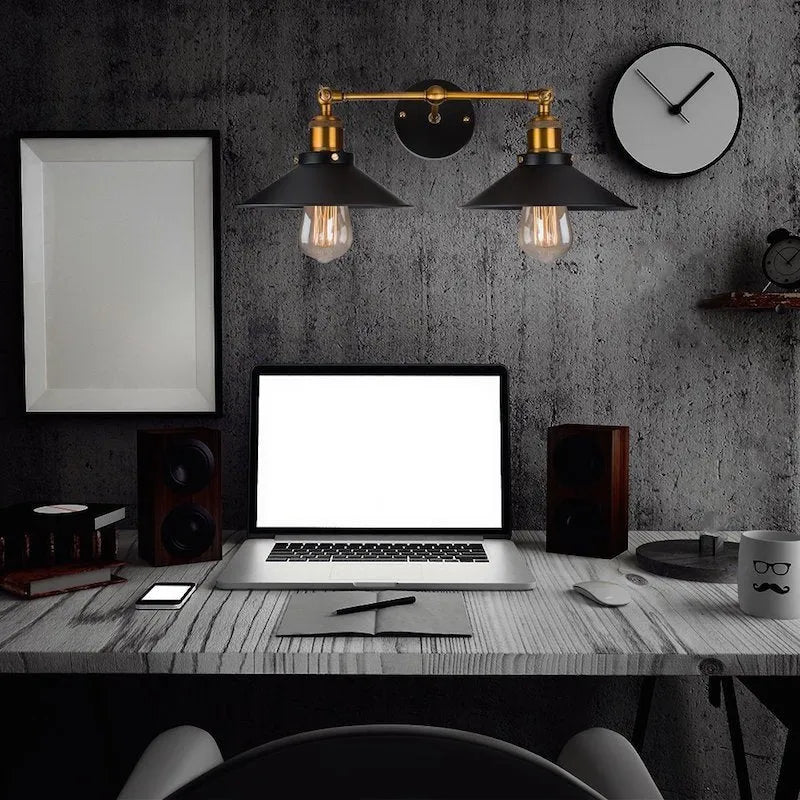 Black double head American retro industrial style iron wall lamp on a wall.